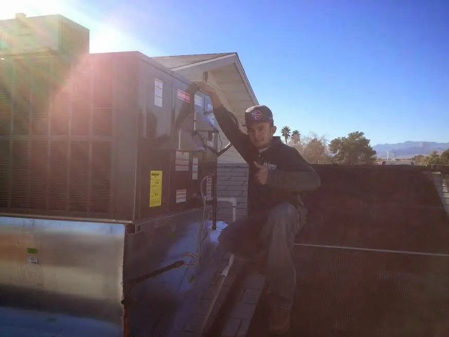HVAC technician performing Boiler Repair on a rooftop unit in Leacock